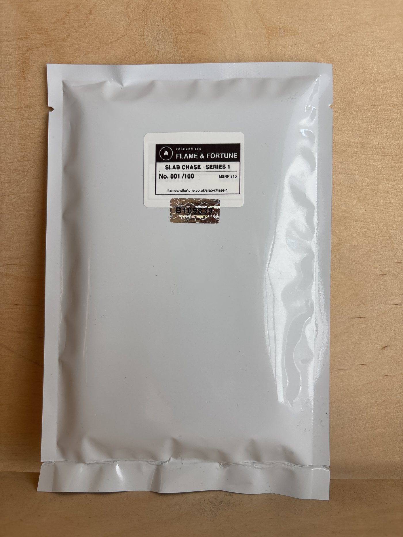 Flame & Fortune Slab Chase Series 1 sealed mylar envelope, No. 001/100, with tamper-evident seal